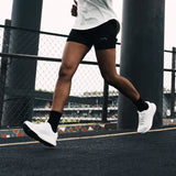 Runner in white Mount to Coast shoes, ideal for road running #Color_white