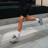 Athlete running in gray Mount to Coast P1 Cinder running shoes #Color_cinder